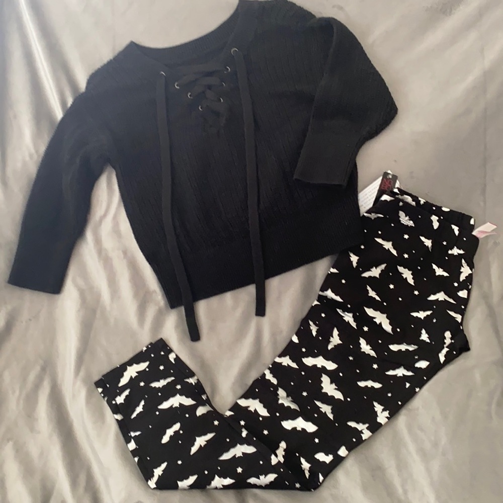 Woman's black sweater with holiday leggings